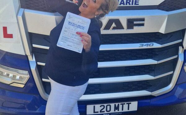 Deborah celebrating after passing her Category CE 3b test at MT Training Gloucestershire