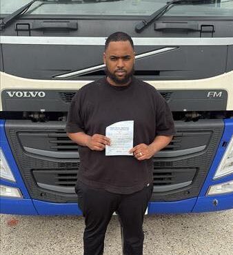 Sharmaake holding his Category C 3b pass certificate at MT Training Newbury