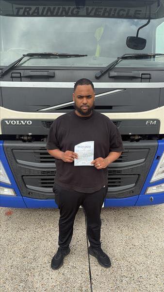 Sharmaake holding his Category C 3b pass certificate at MT Training Newbury