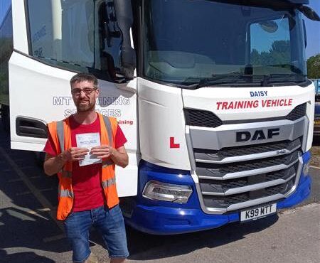 Henry from Burcombe Haulage holding his CE 3b pass certificate at MT Training Plymouth